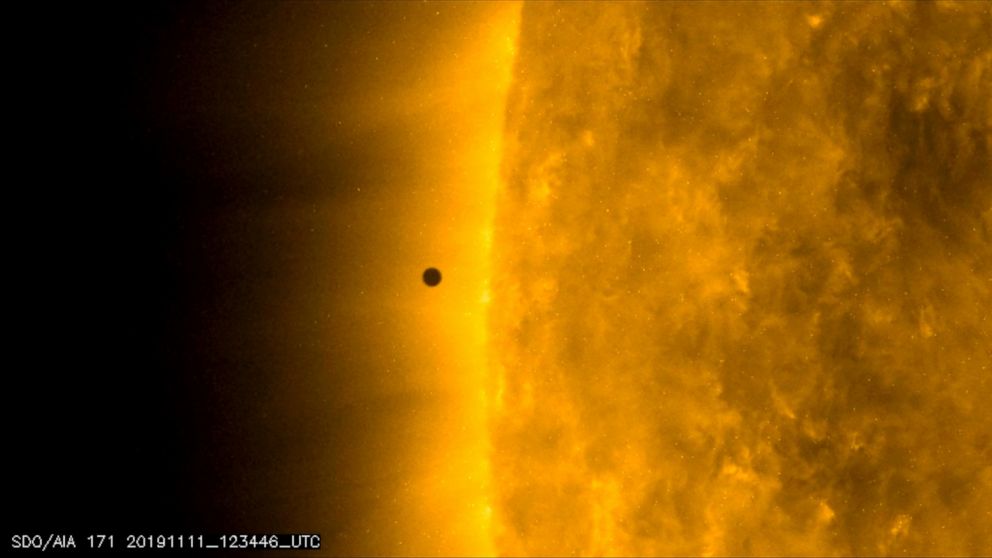 This still image from video issued by NASA's Solar Dynamics Observatory shows Mercury as it passes between Earth and the sun on Monday, Nov. 11, 2019. The solar system's smallest, innermost planet resembles a tiny black dot during the transit, which 