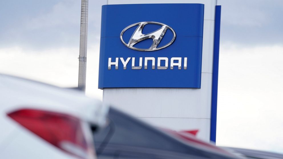 FILE - The Hyundai company logo hangs over a long row of cars at a car dealership in Centennial, Colo., Sunday, Dec. 20, 2020. Georgia officials are close to finalizing a deal with the automaker to build a $5.5 billion electric car plant near Savanna