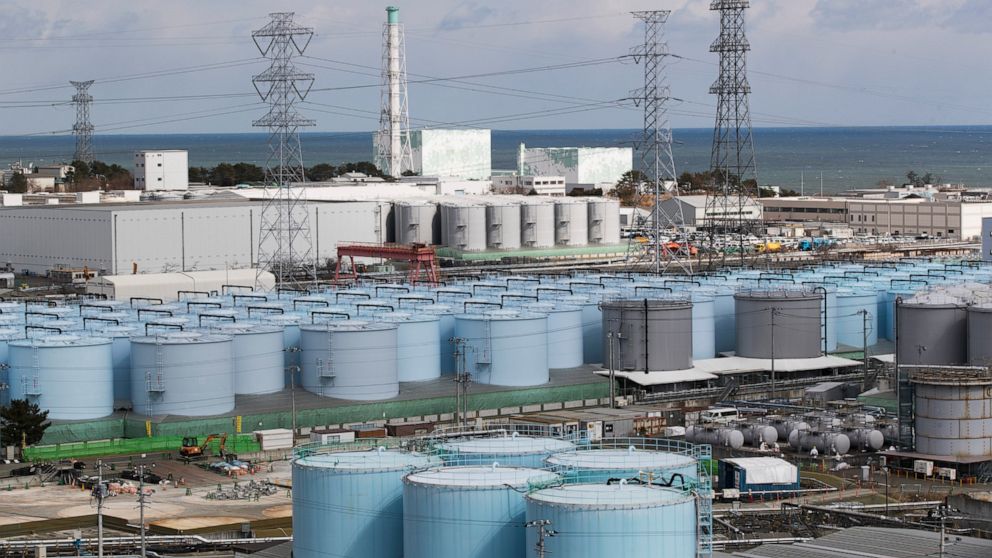FILE - In this Saturday, Feb. 27, 2021, file photo, Nuclear reactors of No. 5, center left, and 6 look over tanks storing water that was treated but still radioactive, at the Fukushima Daiichi nuclear power plant in Okuma town, Fukushima prefecture, 