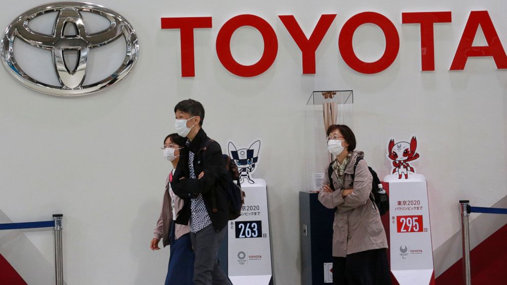 FILE - In this Nov. 2, 2020, file photo, visitors walk at a Toyota showroom in Tokyo. Toyota Motor Corp. has acquired the self-driving division of American ride-hailing company Lyft for $500 million, in a move that underlines the Japanese automaker’s