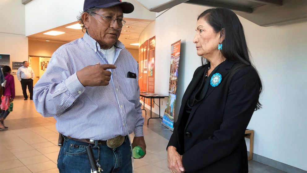 Leslie Begay, left, speaks with U.S. Rep. Deb Haaland, D-New Mexico, in a hallway outside a congressional field hearing in Albuquerque, N.M., highlighting the atomic age's impact on Native American communities on Monday, Oct. 7, 2019. Begay, a former