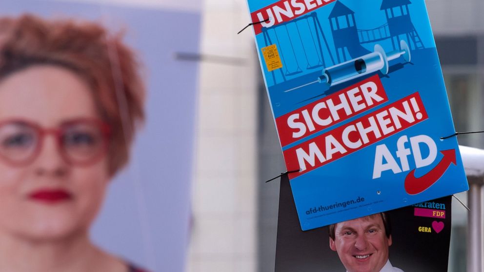 In this Friday, May 17, 2019 photo an AfD poster (top right) hangs on a street light during the street Europe and communal election campaigning of the far-right Alternative for Germany AfD in Gera, Germany. In Germany, the far-right AfD party is domi