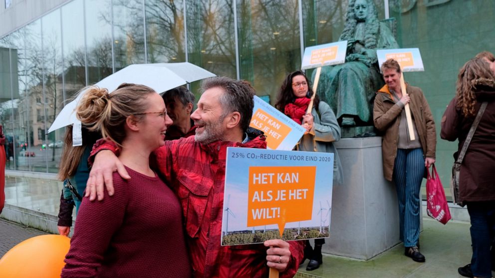 Climate activists gather outside the Supreme Court of the Netherlands, The Hague, on Friday Dec. 20, 2019, ahead of a ruling in a landmark case in which the government was ordered to slash greenhouse gas emissions by 25% by 2020. The government appea
