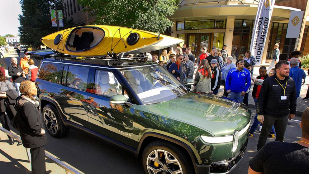 FILE - Large crowds turned out to look at Rivian Automotive's R1S prototype during a public rollout of the company's new vehicles in Normal, Illinois, Sunday, Oct. 13,2019. Electric vehicle maker Rivian Automotive will announce Thursday, Dec. 15, 202