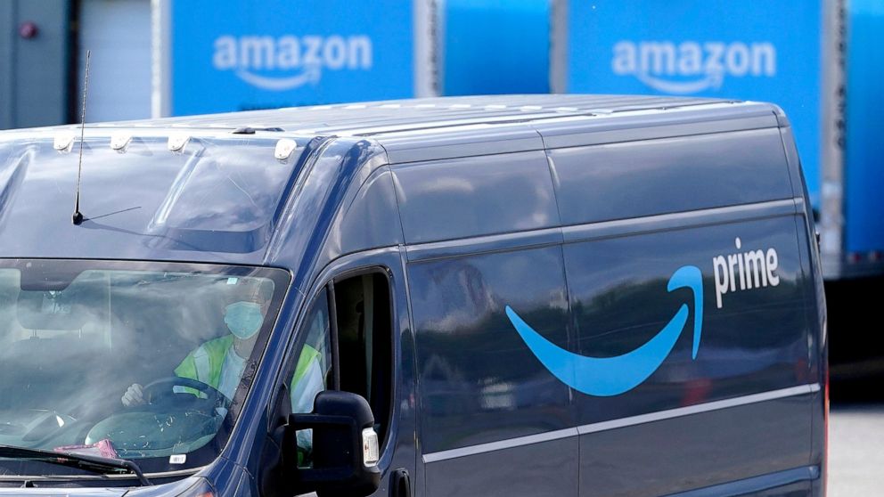 FILE - An Amazon Prime logo appears on the side of a delivery van as it departs an Amazon Warehouse location in Dedham, Mass., Oct. 1, 2020. Amazon said Monday, Oct. 10, 2022, that it will invest 1 billion euros ($972.1 million) to add thousands of m