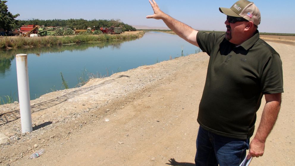 Kevin Spesert, public affairs and real estate manager for the Sites Project Authority, points out the main canal of the Glenn Colusa Irrigation District, on Friday, July 23, 2021, near Sites, Calif. The canal would be one of the primary sources of wa