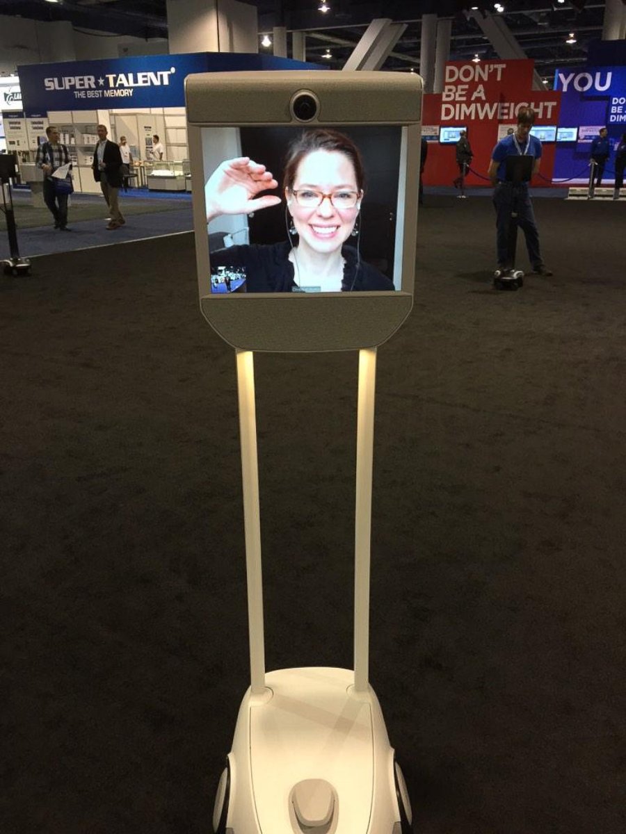 PHOTO: ABC News' Neal Karlinsky talks to a woman who telecommutes out of state via this remote-controlled robot on wheels at CES 2015 on Jan. 7, 2015.