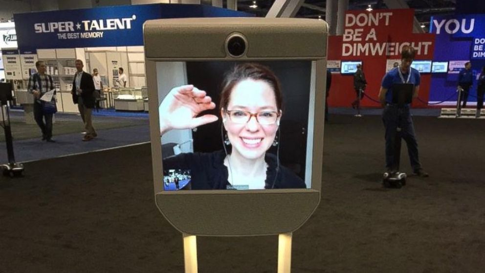 PHOTO: ABC News' Neal Karlinsky talks to a woman who telecommutes out of state via this remote-controlled robot on wheels at CES 2015 on Jan. 7, 2015.