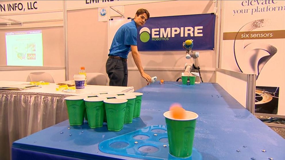PHOTO: A robot tosses a pingpong ball in a round of beer pong at CES 2015.