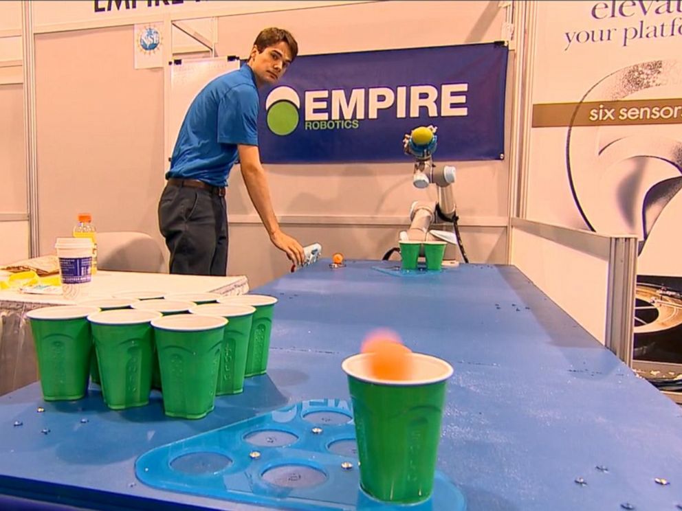 PHOTO: A robot tosses a pingpong ball in a round of beer pong at CES 2015.