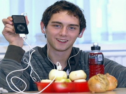 Picture of boy with an iPod and onion.