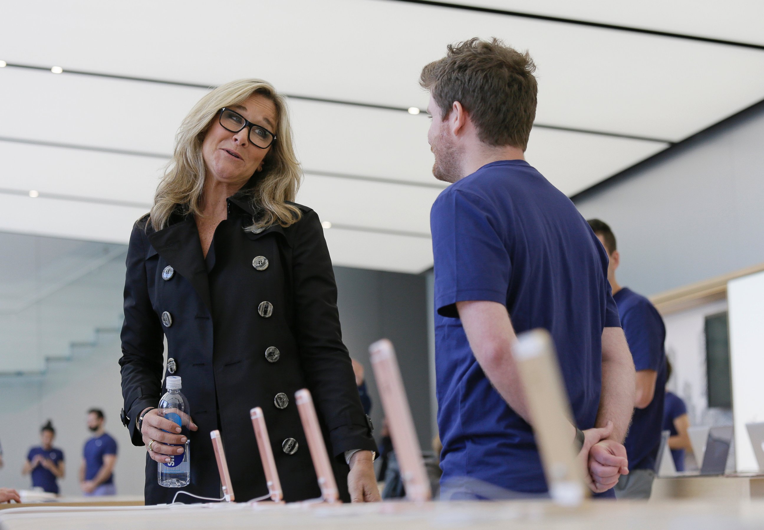 Angela Ahrendts, Apple's senior vice president of retail and online stores, speaks with an employee during a preview of the new Apple Union Square store, Thursday, May 19, 2016, in San Francisco.