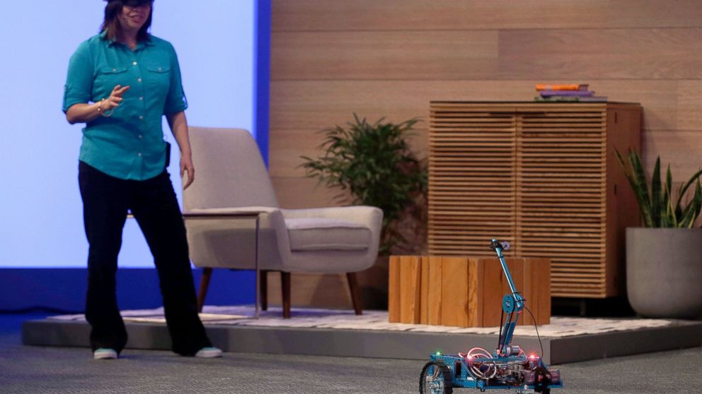 A woman wearing a HoloLens demonstrates how the technology can be used to test and develop robotics at the Microsoft Build conference in San Francisco, April 29, 2015.