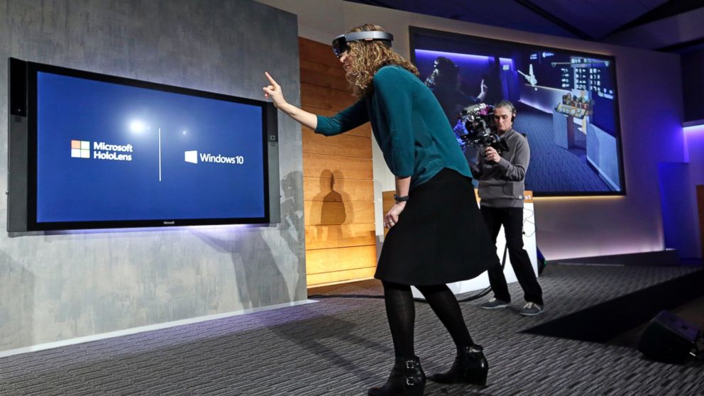 PHOTO: Microsoft's Lorraine Bardeen demonstrates a hologram device as what she "sees" is projected on a screen at the company's headquarters on Jan. 21, 2015, in Redmond, Wash.
