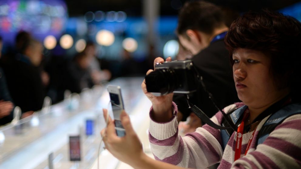 PHOTO: An attendee takes a picture of a device at the Mobile World Congress, the world's largest mobile phone trade show in Barcelona, Spain, on March 2, 2015.