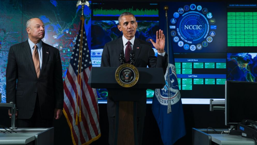 Homeland Security Secretary Jeh Johnson listens at left as President Barack Obama speaks at the National Cybersecurity and Communications Integration Center in Arlington, Va., Jan. 13, 2015. Ob