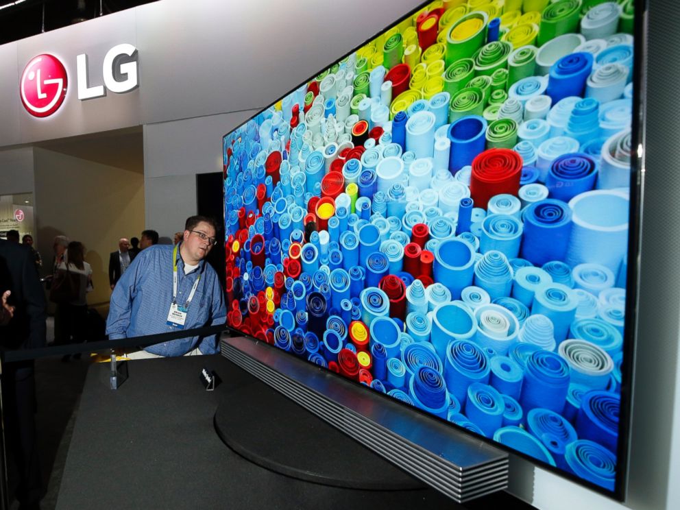 PHOTO:  Brian Benson eyes the slim depth of the LG  65" 4K ULTRA HD OLED TV at the 2015 International CES on Tuesday, Jan. 6, 2015, in Las Vegas. 