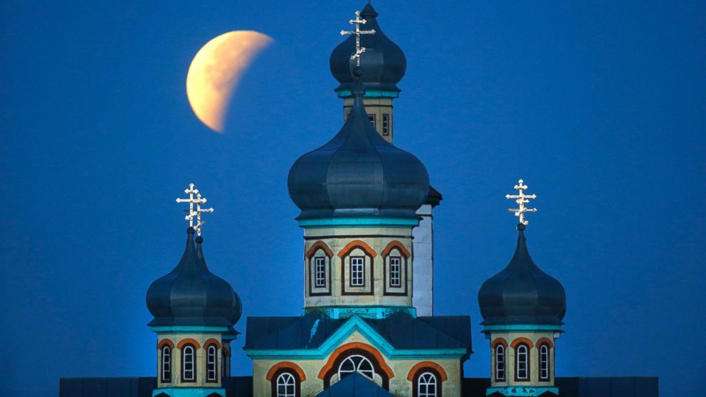 PHOTO: A supermoon is seen at the finish of a lunar eclipse behind an Orthodox church in Turets, Belarus, Sept. 28, 2015.