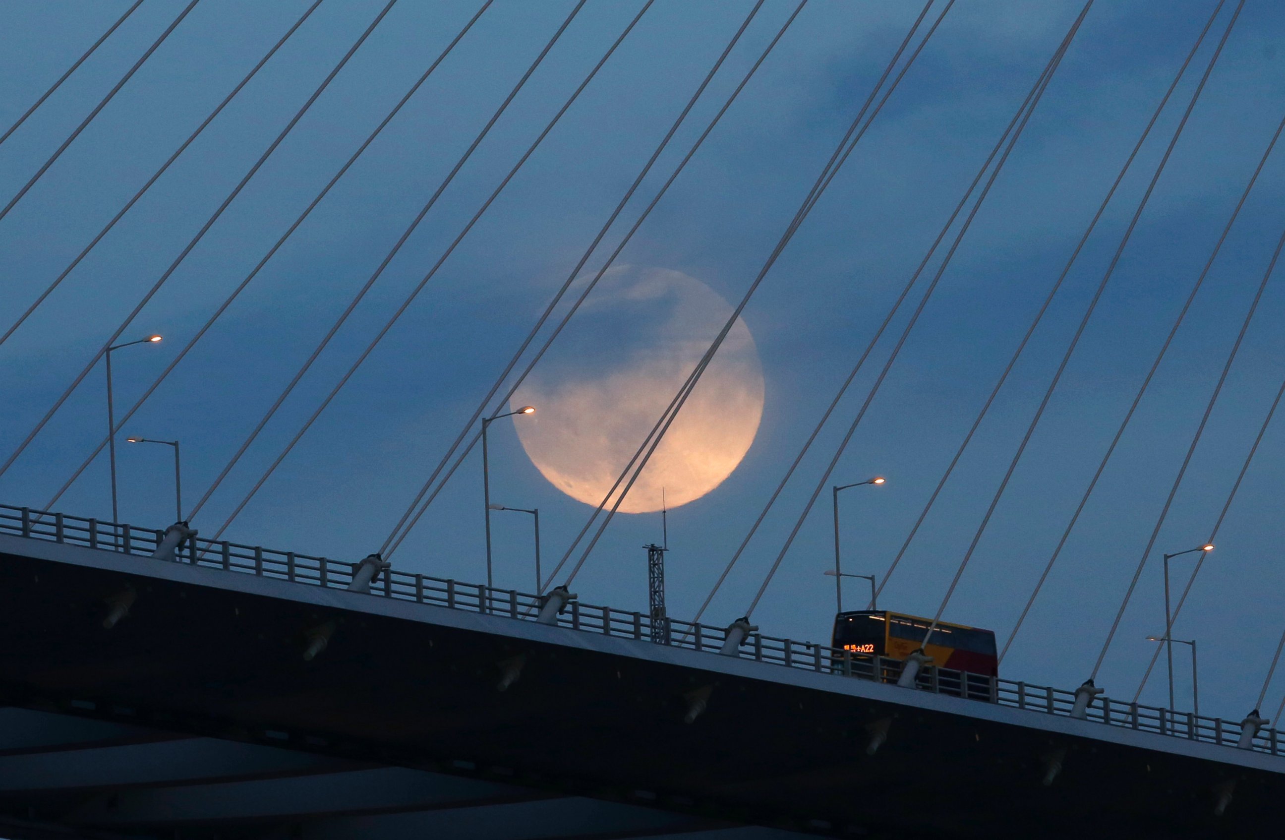 PHOTO: A perigee moon, also known as a supermoon, raises over a bridge in Hong Kong on Aug. 10, 2014.