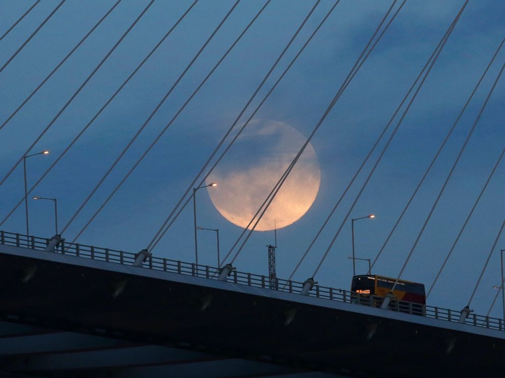 PHOTO: A perigee moon, also known as a supermoon, raises over a bridge in Hong Kong on Aug. 10, 2014.