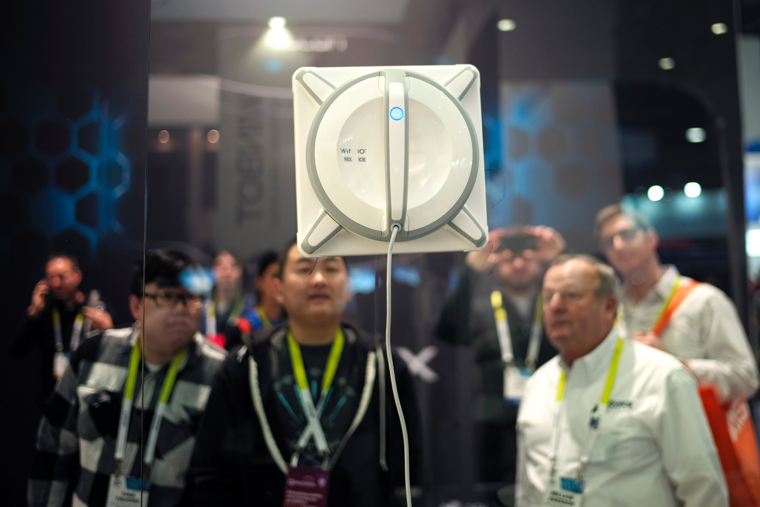 PHOTO: Attendees watch a Winbot, a window cleaning robot, clean the window at the Ecovacs Robotics booth at the International CES, on Jan. 6, 2015, in Las Vegas.