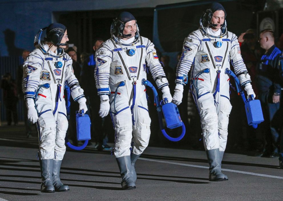 PHOTO: From left, U.S. astronaut Christina Hammock Koch, Russian cosmonaut Alexey Ovchinin, and U.S. astronaut Nick Hague walk in their space suits prior the launch of Soyuz MS-12 space ship at the Baikonur cosmodrome, Kazakhstan, March 14, 2019.