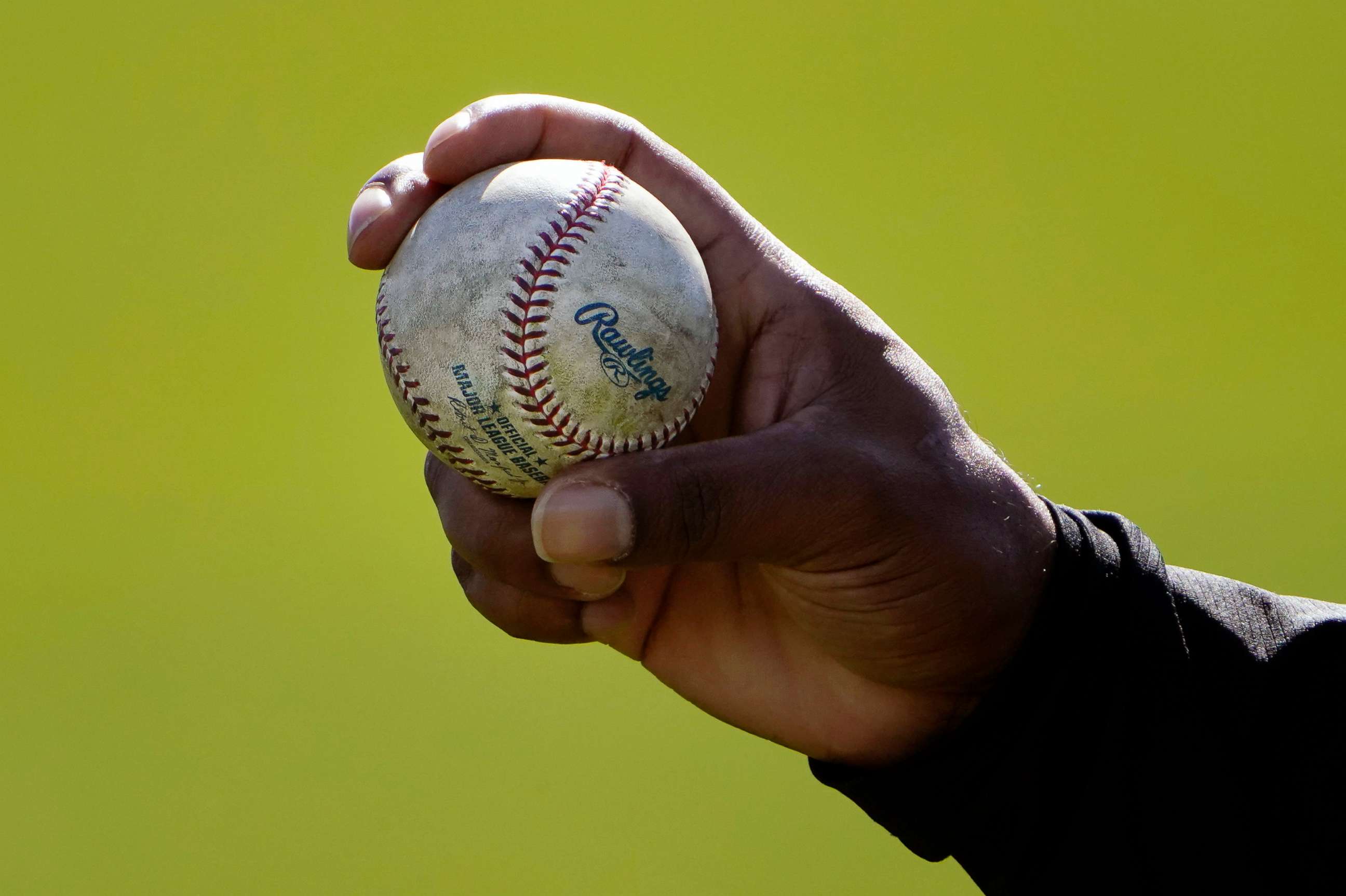PHOTO: A Colorado Rockies pitcher shows his grip to a teammate during a spring training baseball workout in Scottsdale, Ariz., in this Wednesday, Feb. 24, 2021, file photo.