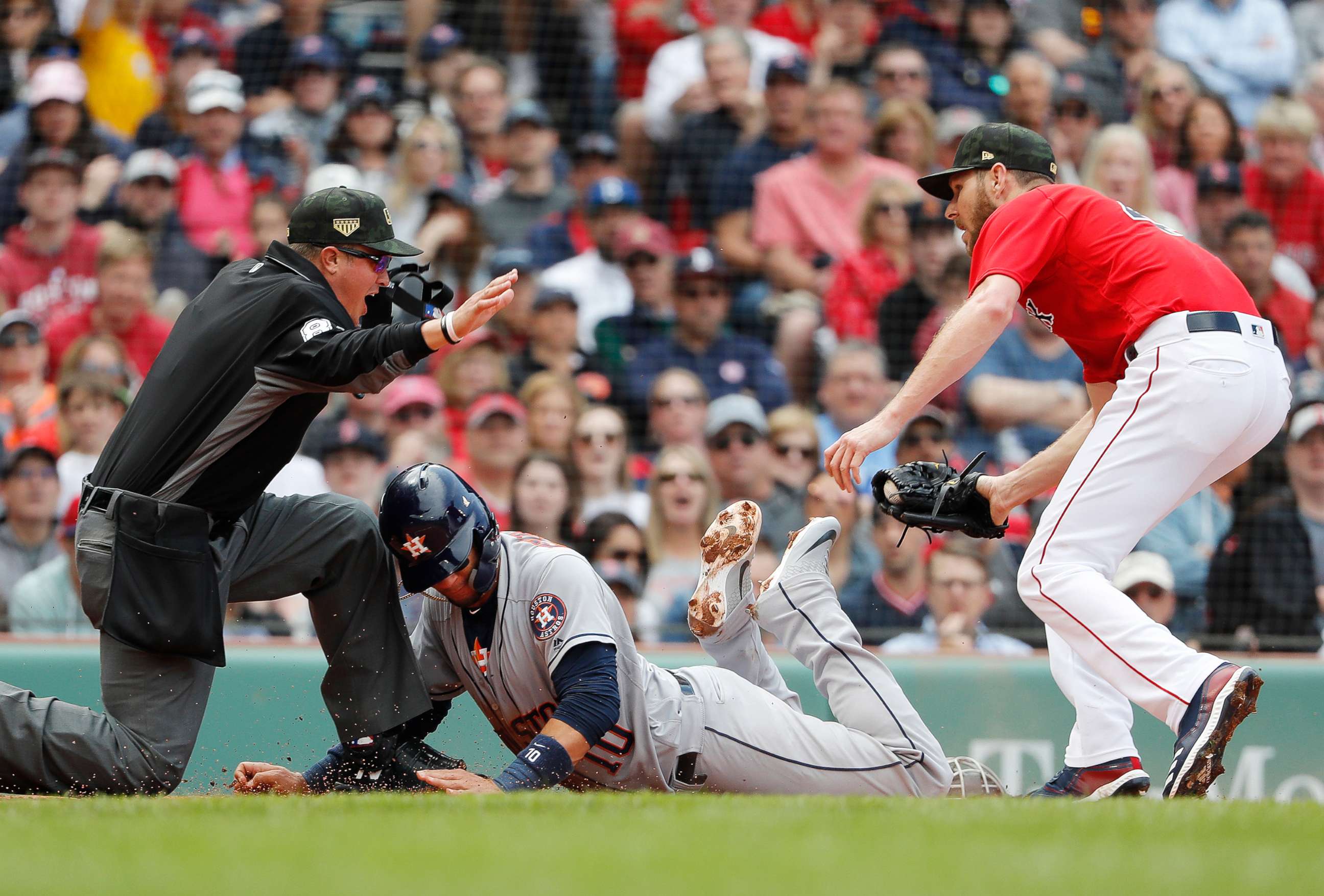PHOTO: Houston Astros' Yuli Gurriel, center, is called safe by umpire Cory Blaser, left, after scoring on a wild pitch by starting pitcher Chris Sale, right, during the second inning of a baseball game, May 19, 2019, at Fenway Park in Boston.