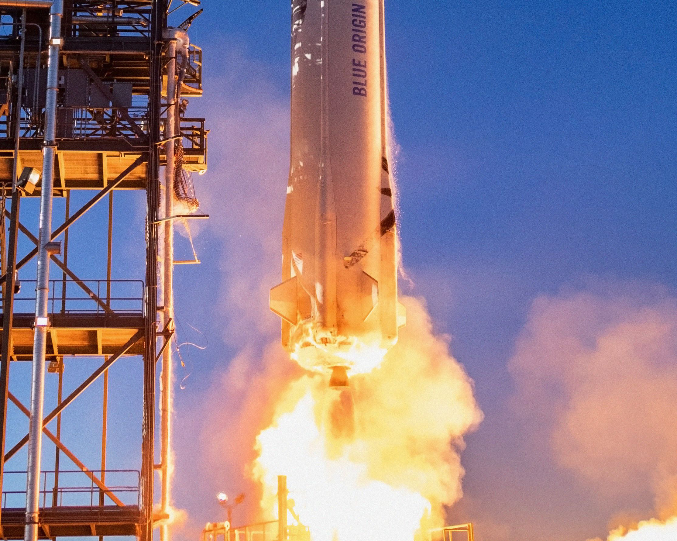 PHOTO: This undated handout photo obtained May 19, 2021, courtesy of Blue Origin, shows a close-up of the New Shepard rocket as it launches in West Texas.