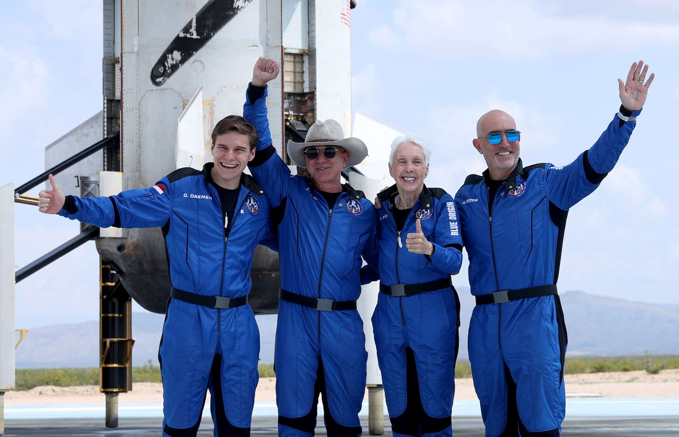 PHOTO: Blue Origin's New Shepard crew (L-R) Oliver Daemen, Jeff Bezos, Wally Funk, and Mark Bezos pose for a picture near the booster after flying into space in the Blue Origin New Shepard rocket on July 20, 2021 in Van Horn, Texas.