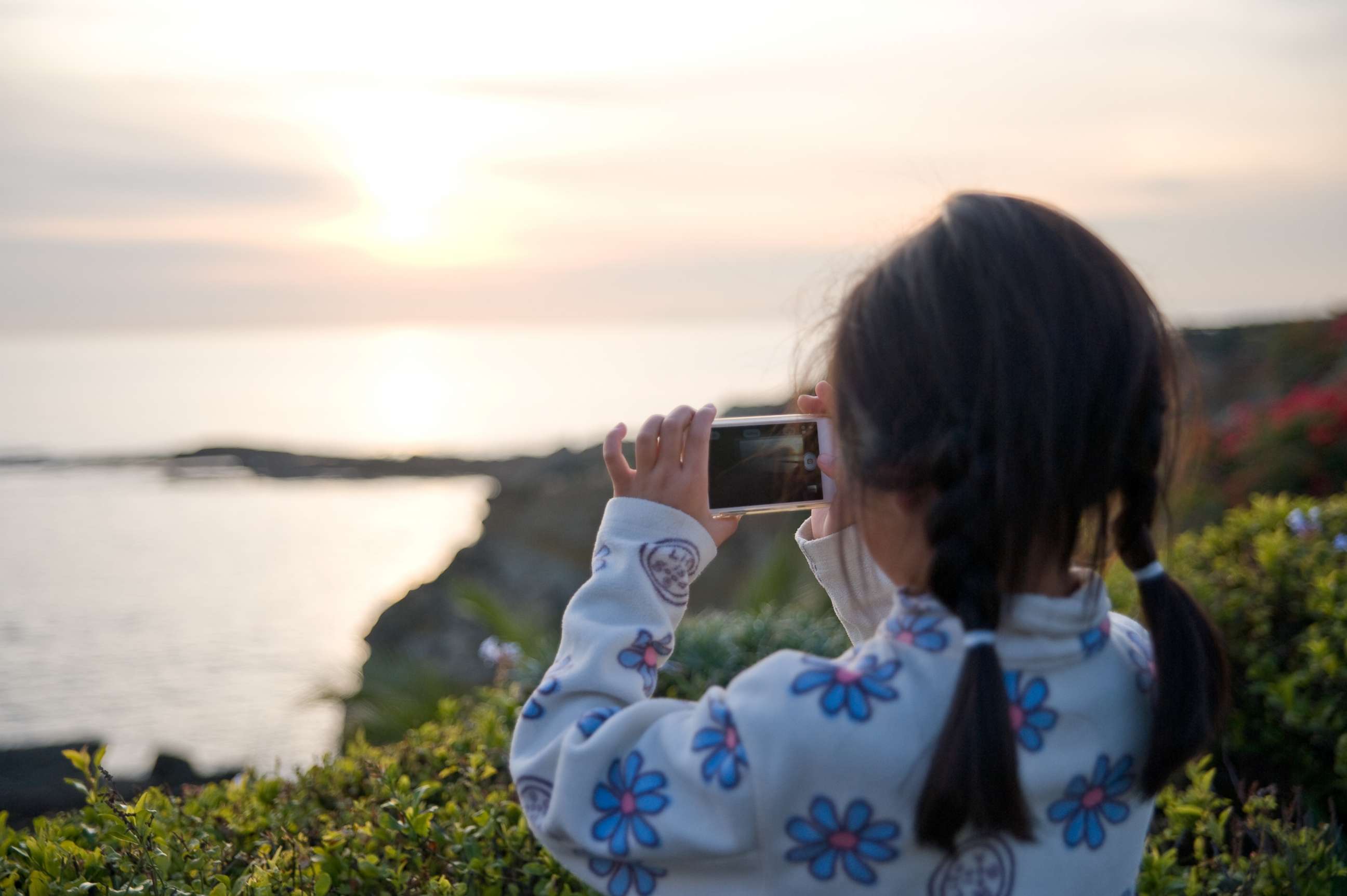 PHOTO:  A young girl photographs the sunset at the beach using a smartphone, Jan. 5, 2013  in Laguna, Calif.