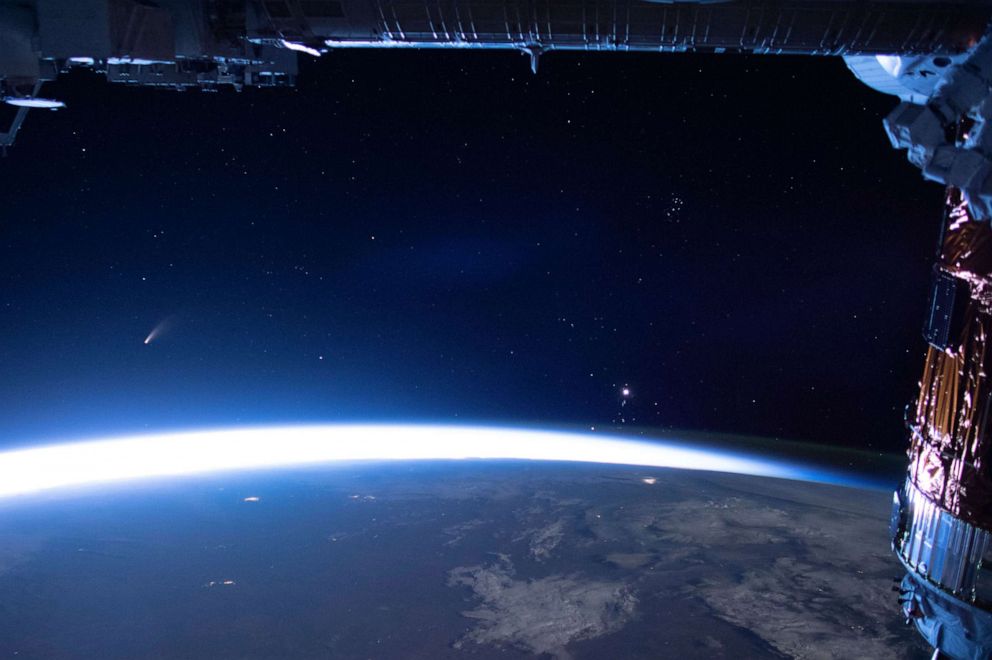 PHOTO: In this image released by NASA, Comet Neowise, left, is seen in the eastern horizon above Earth in this image taken from the International Space Station on Sunday, July 5, 2020.