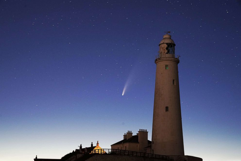 PHOTO: Comet Neowise passes behind St Mary's Lighthouse in Whitley Bay, United Kingdom, in the early hours of July 13, 2020.