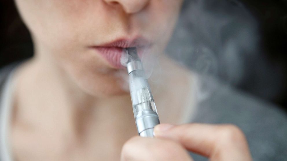 PHOTO: Young woman smoking an e-cigarette.