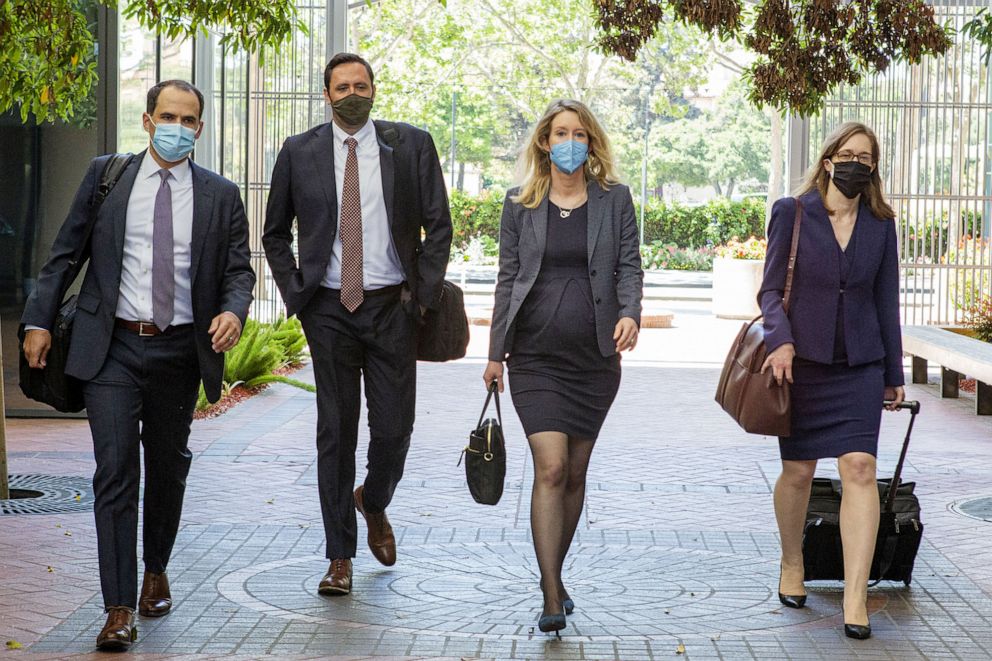 PHOTO: Elizabeth Holmes, founder and former chief executive officer of Theranos Inc., center right, arrives with her legal team at U.S. federal court in San Jose, Calif., U.S., May 6, 2021. 