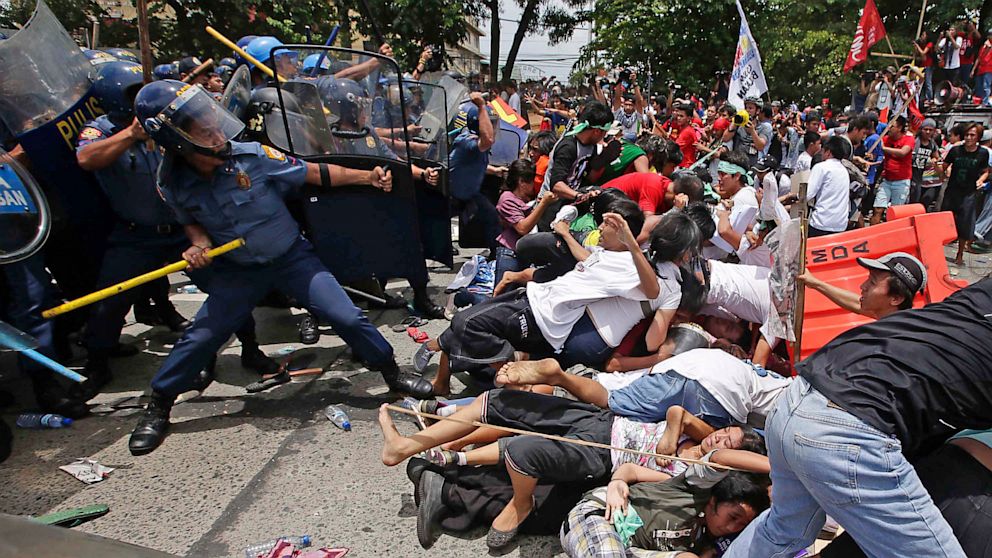 Riot police clash with protesters attempting to reach the Philippine Congress in Quezon City, Philippines, in this July 22, 2013 photo.