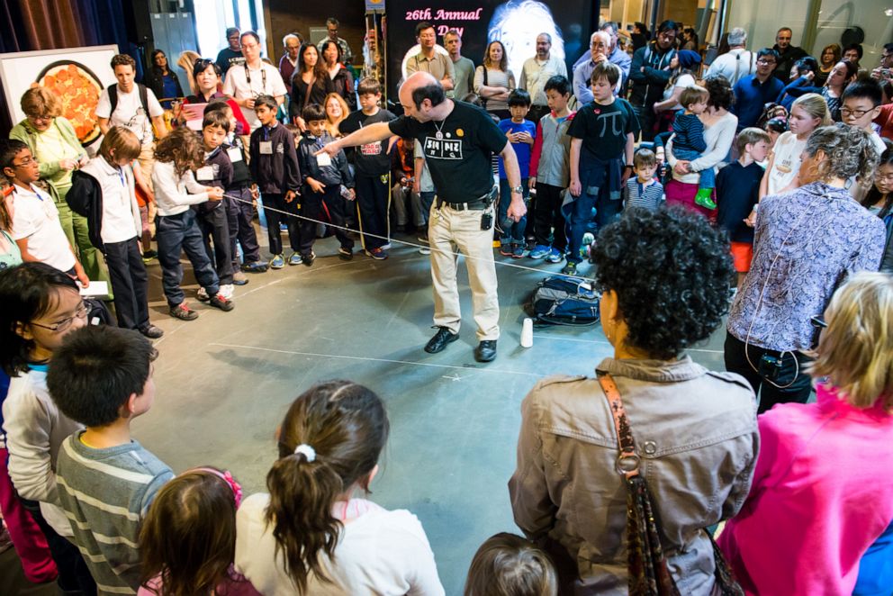 PHOTO: Exploratorium attendees show children how pi is the ratio of a circle's circumference to its diameter during Pi Day in San Francisco, Thursday, March 14, 2013.