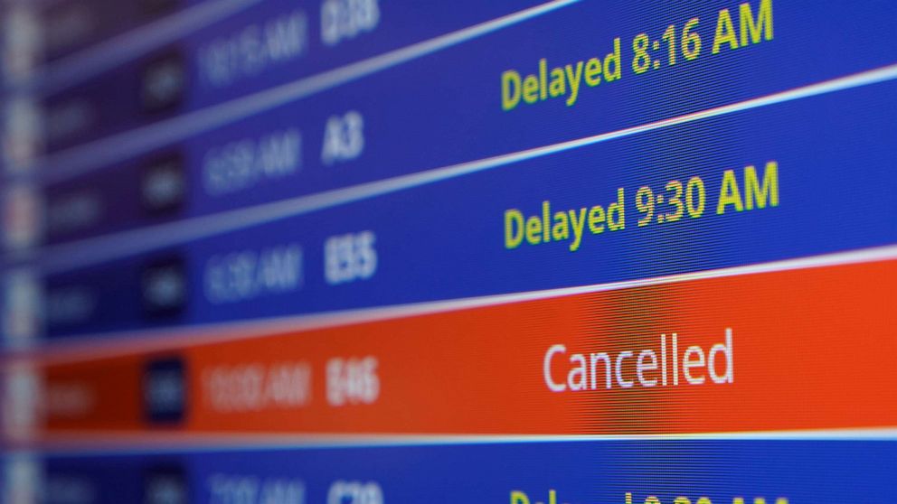 PHOTO: A video board shows flight delays and cancellations at Ronald Reagan Washington National Airport in Arlington, Va., Jan. 11, 2023.