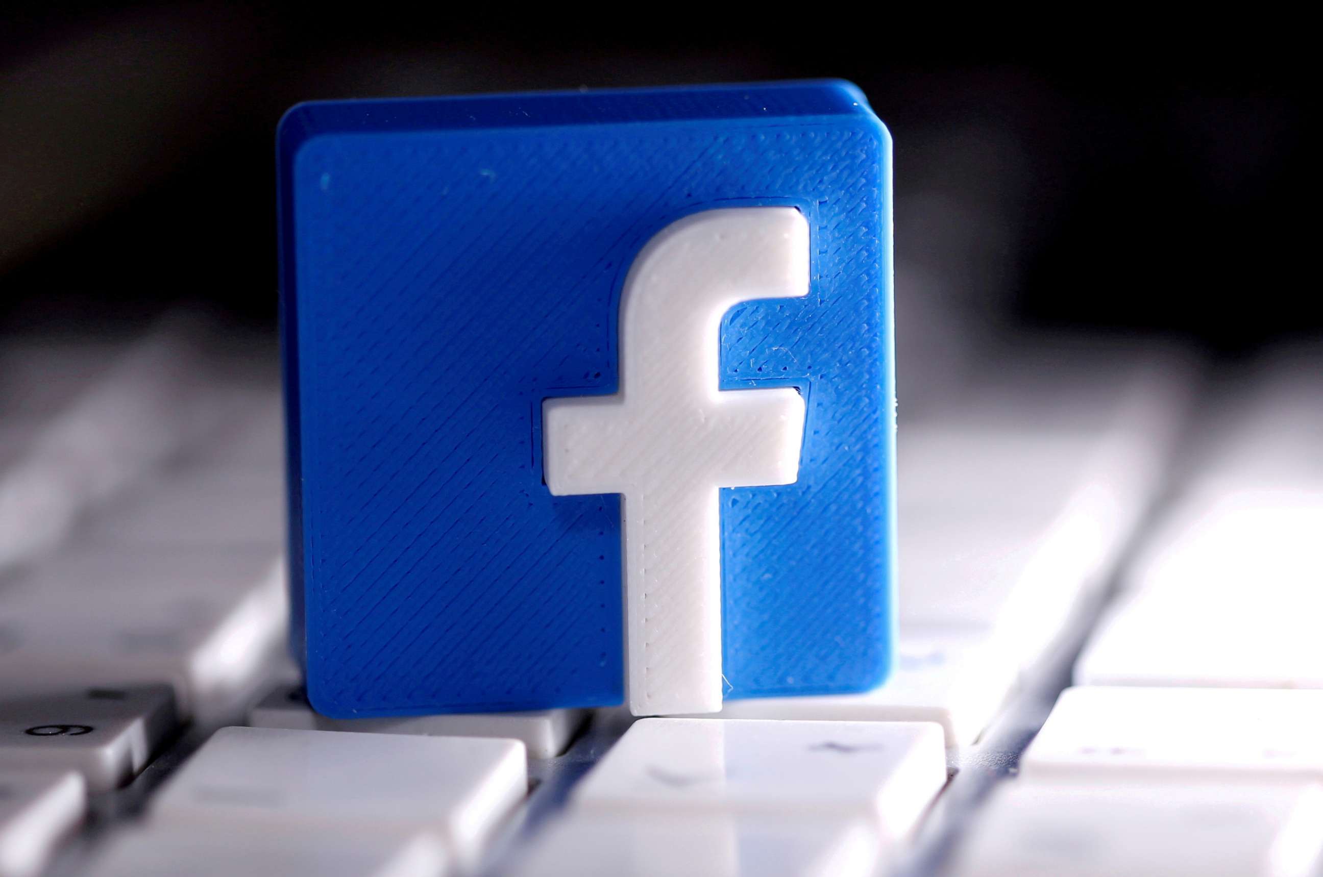 PHOTO: A 3D-printed Facebook logo is seen placed on a keyboard in this illustration taken March 25, 2020.