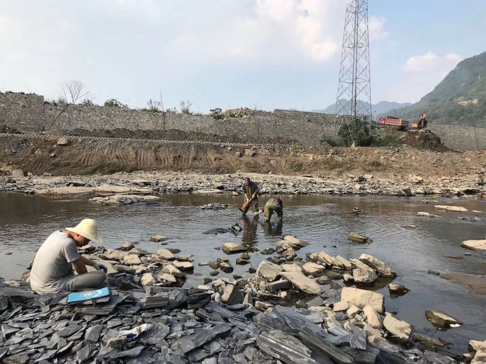 PHOTO: Researchers working on a river bed near the junction of the Danshui River with Qingjiang River in Hubei Province, China, March 26, 2019. 