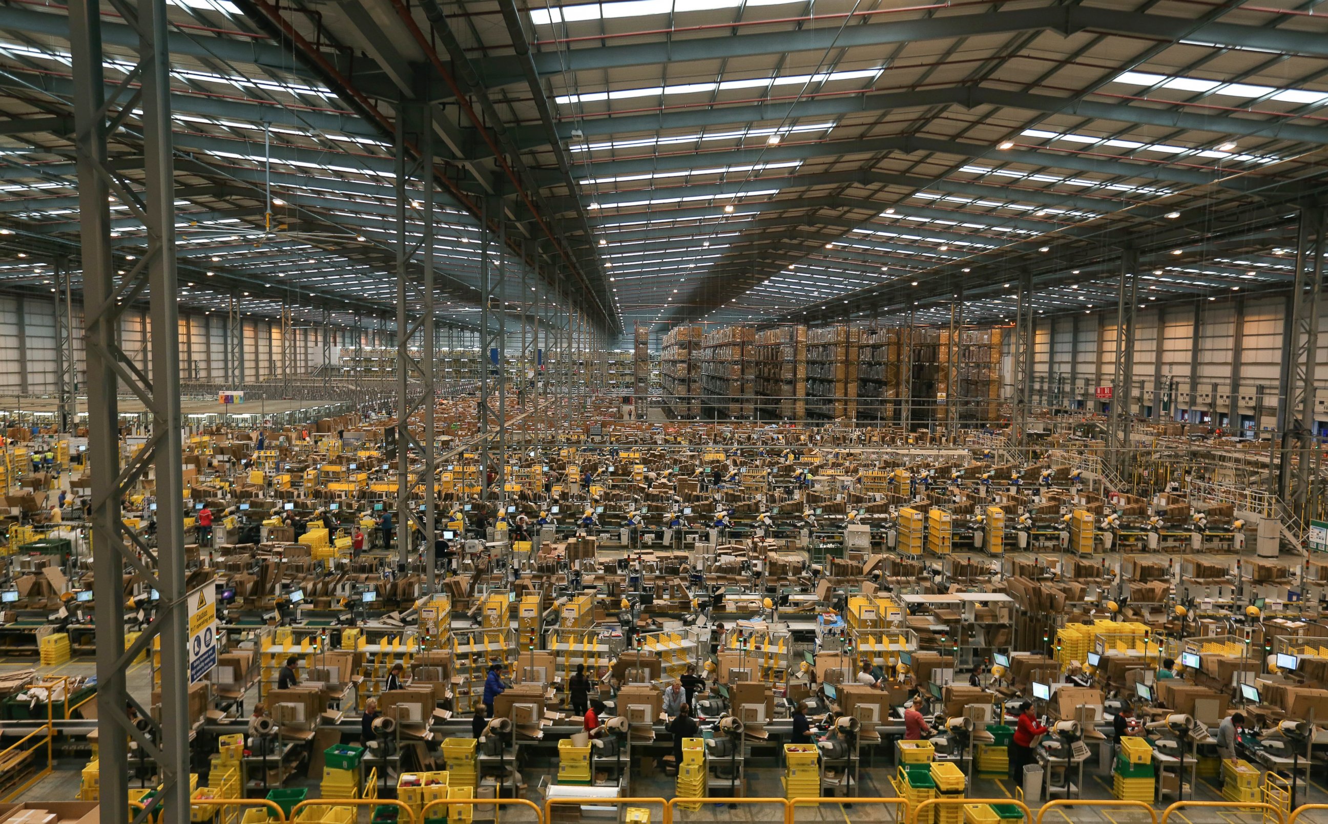 PHOTO: Employees work on the warehouse floor at one of Amazon.com Inc.'s fulfillment centers, Nov. 25, 2014, in Peterborough, U.K. 