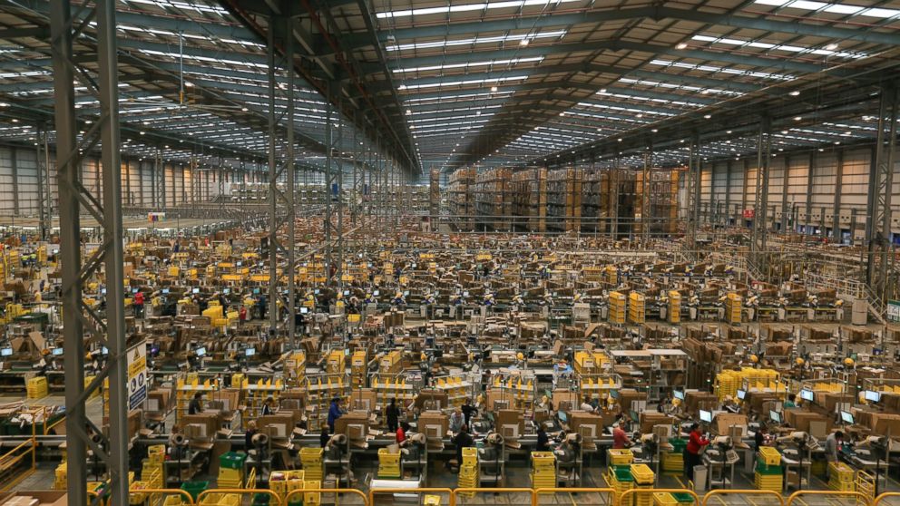 PHOTO: Employees work on the warehouse floor at one of Amazon.com Inc.'s fulfillment centers, Nov. 25, 2014, in Peterborough, U.K. 