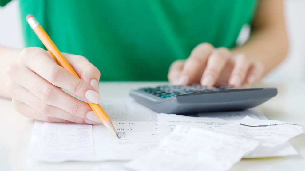 A woman reviewing bills. 