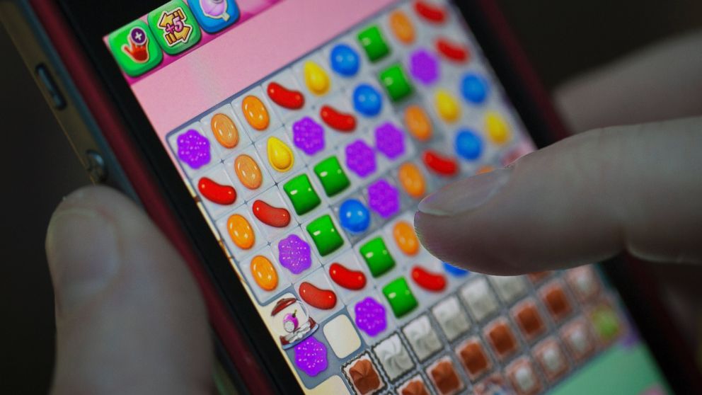 A user plays "Candy Crush Saga" on a phone in London, Feb. 18, 2014.