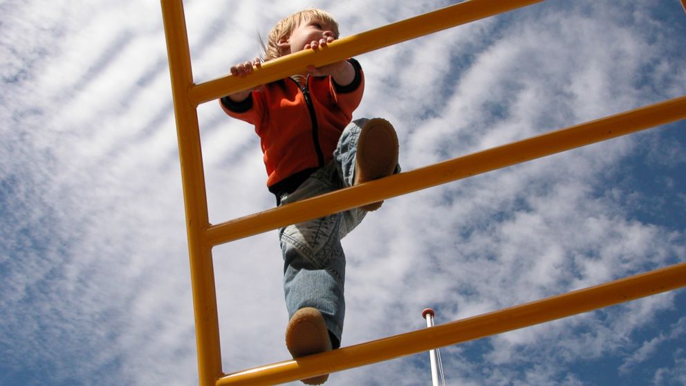 A young boy climbs on a jungle gym in an undated stock photo.