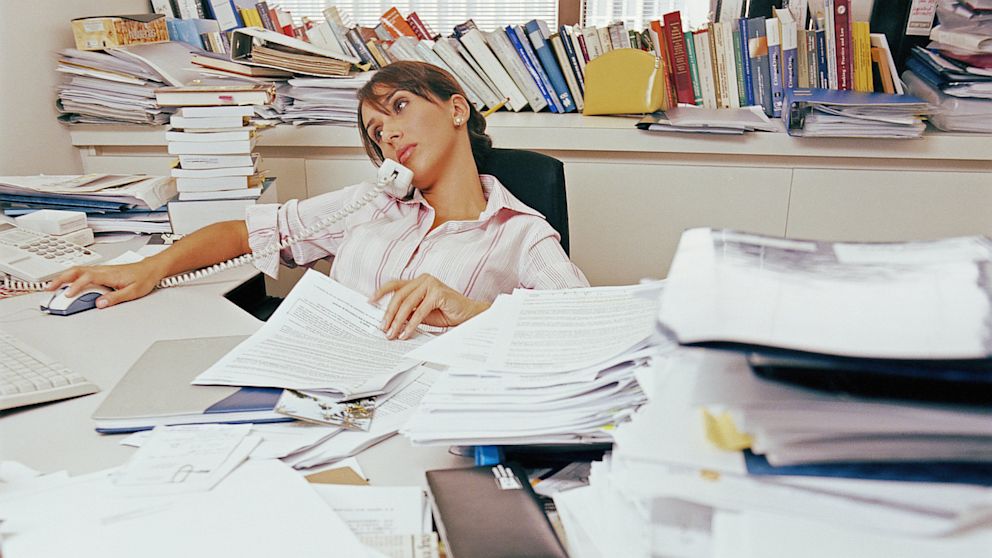 PHOTO: Woman with cluttered desk