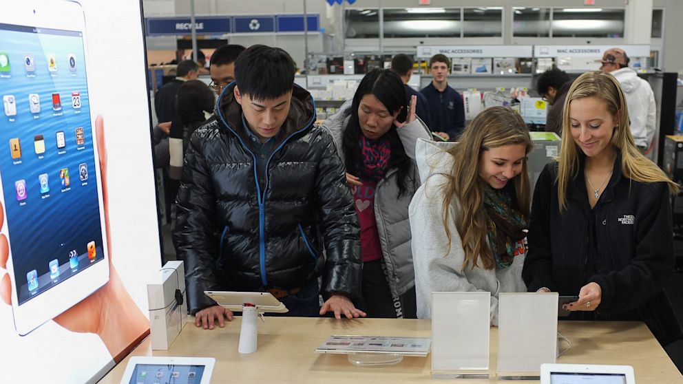 In this file photo, shoppers gather around a display for the Apple ipad mini inside of a Best Buy store during their Black Friday sale which started at midnight on November 23, 2012 in Rockville, Maryland. 