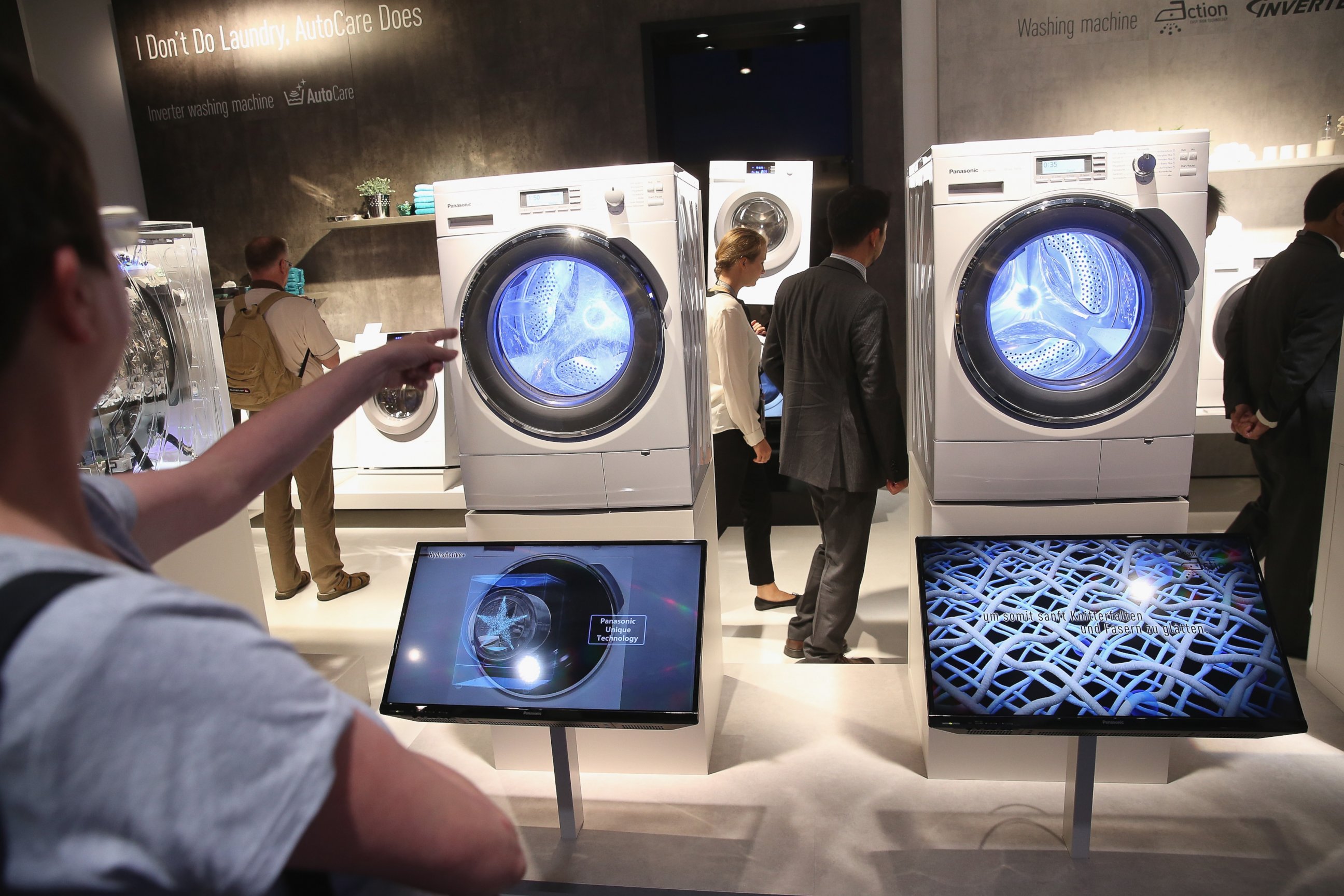 PHOTO: Visitors look at the latest generation of smart technology washing machines at the Panasonic stand at the 2014 IFA home electronics and appliances trade fair in Berlin, Sept. 5, 2014.