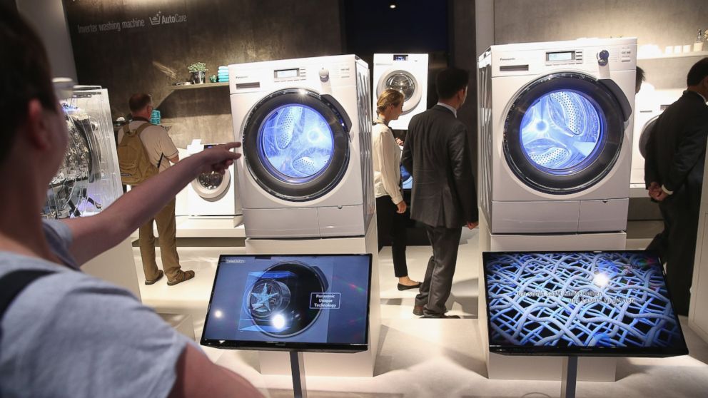 PHOTO: Visitors look at the latest generation of smart technology washing machines at the Panasonic stand at the 2014 IFA home electronics and appliances trade fair in Berlin, Sept. 5, 2014.