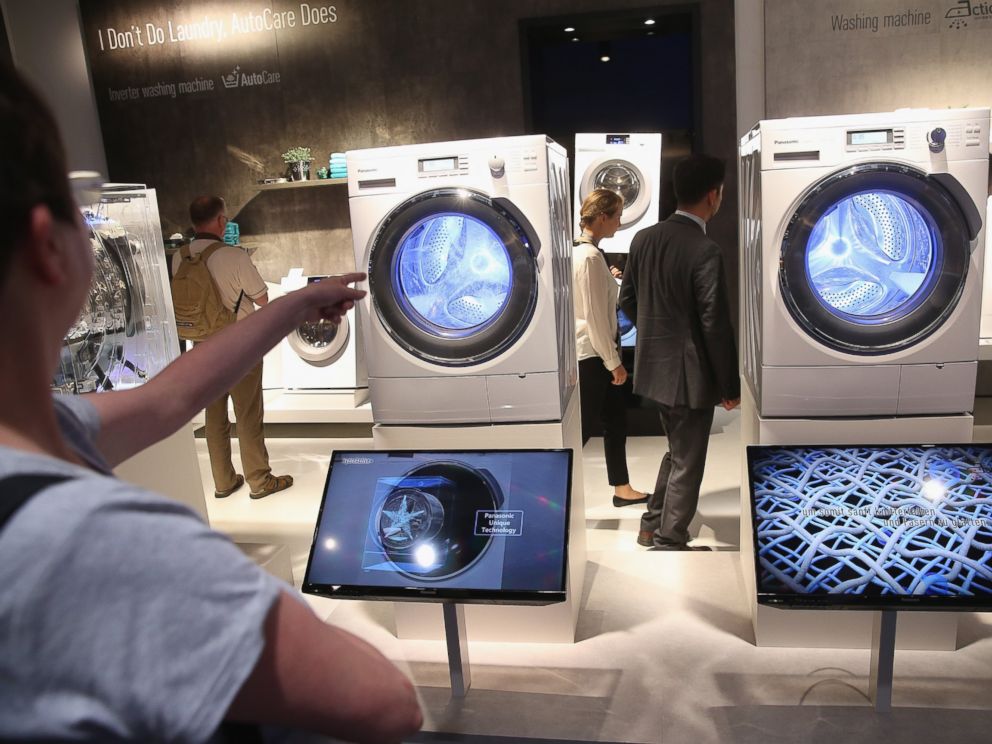 PHOTO: Visitors look at the latest generation of smart technology washing machines at the Panasonic stand at the 2014 IFA home electronics and appliances trade fair in Berlin, Sept. 5, 2014.